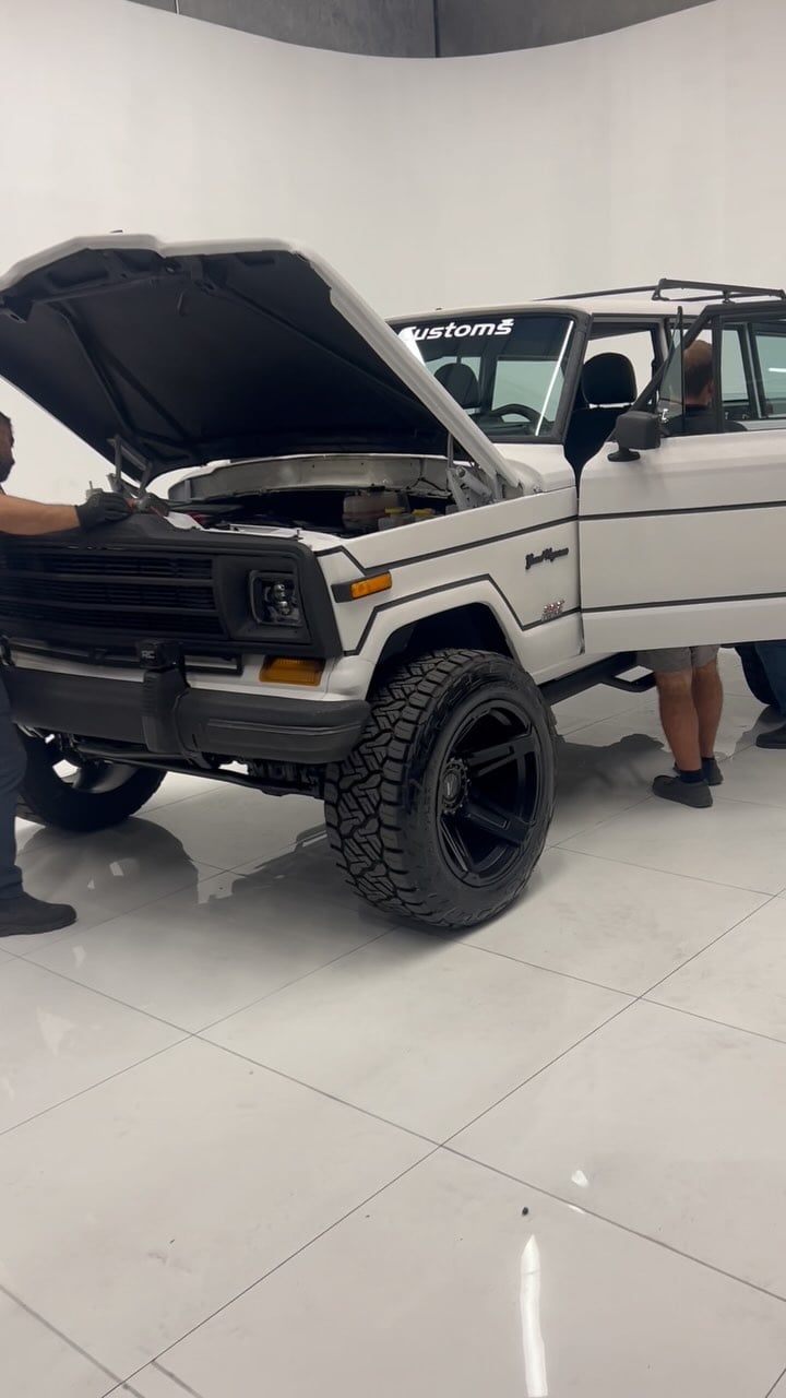 Finish line on this stunning Restomod — The exterior: an old school Jeep Grand Wagoner covered in Pearl White Kevlar Armor - The Interior: all modern Jeep tech including Apple CarPlay, Bluetooth, back up camera, ABS brakes, cold a/c, power windows, traction control, power steering and much more - Under The Hood: 392 Hemi V8 that shuns out 520 raging horses - want one? Contact us today